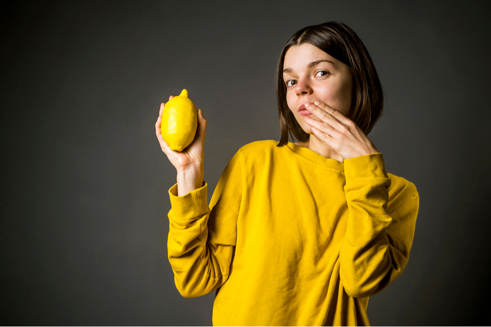 A girl holding a lemon